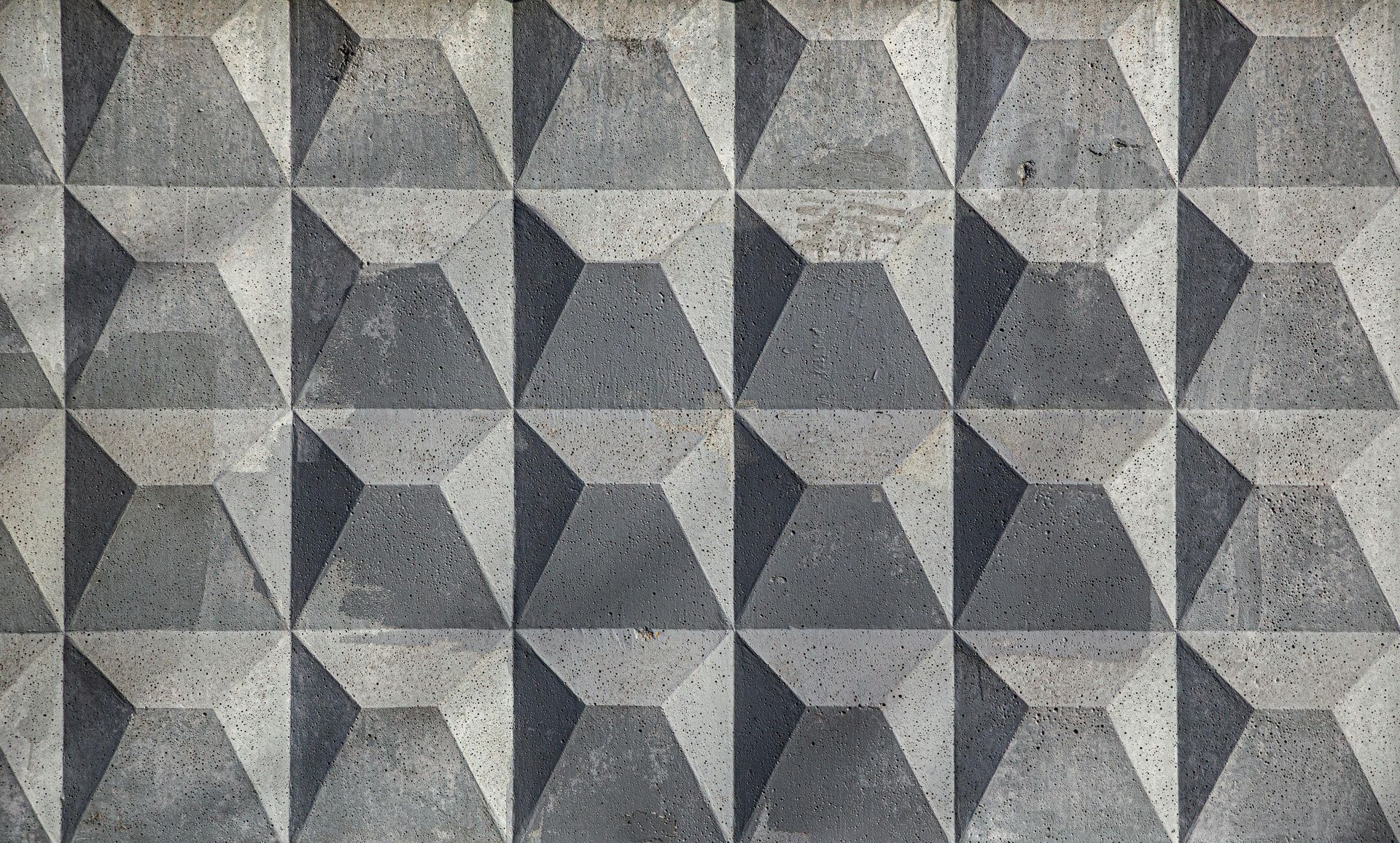 A close up of a concrete wall with a geometric pattern.