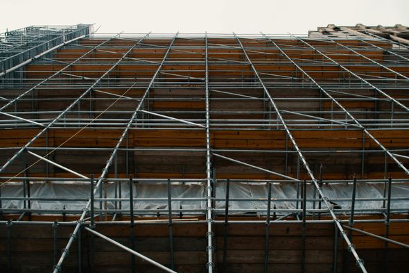 A building under construction with a lot of scaffolding on it.