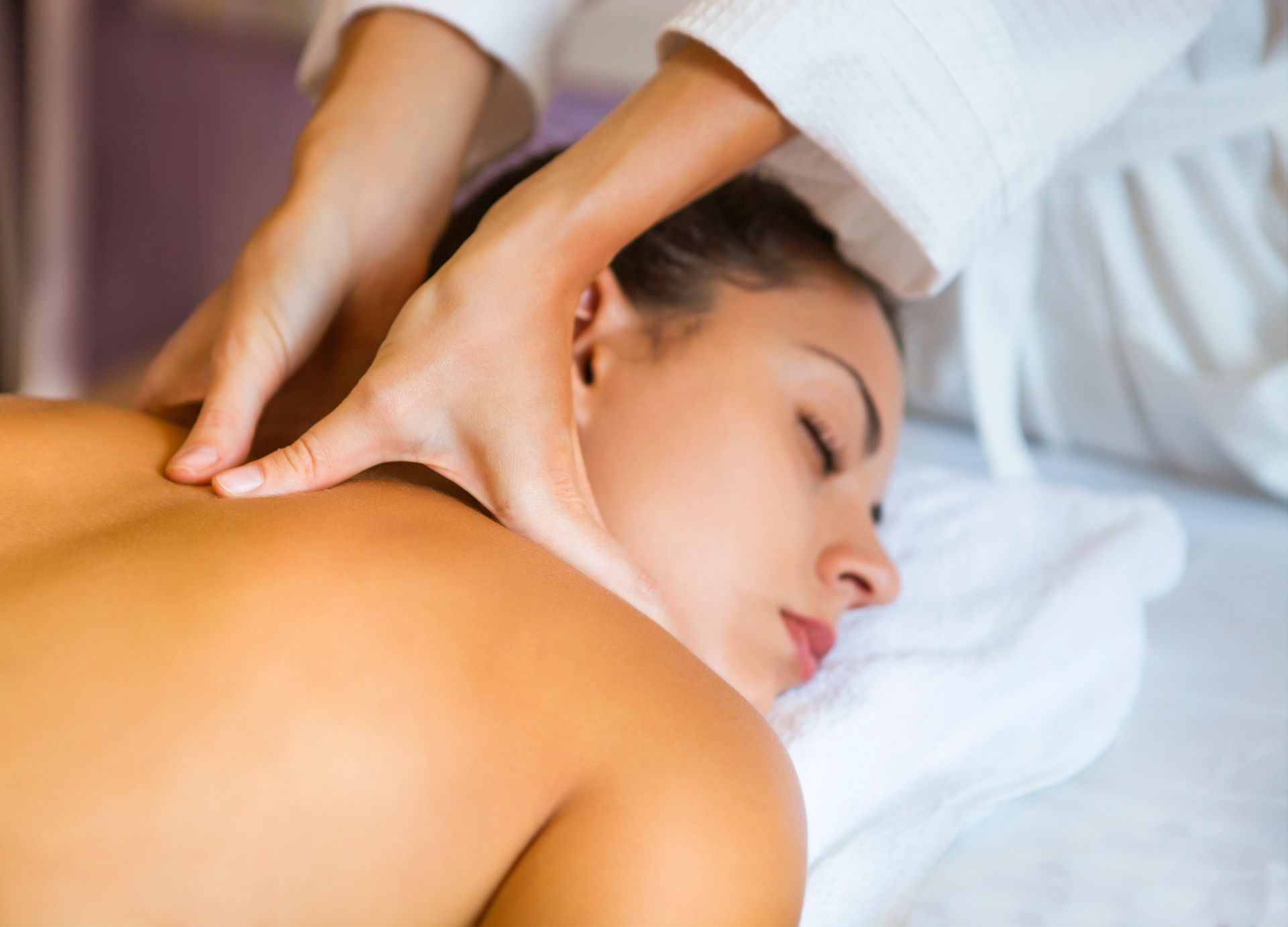 A woman receives a shoulder massage at a spa - Thames, NZ - Thai Classic Massage Thames