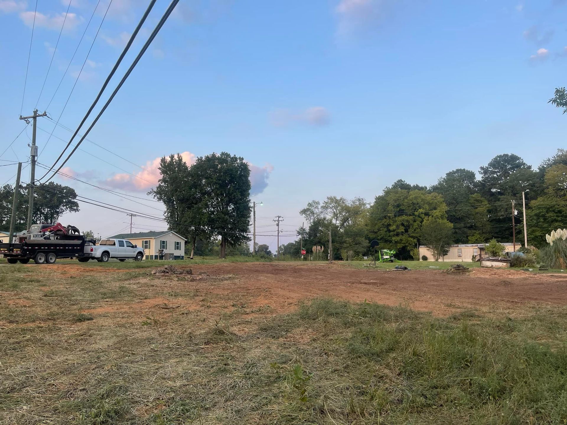 A truck is parked in the middle of a dirt field.