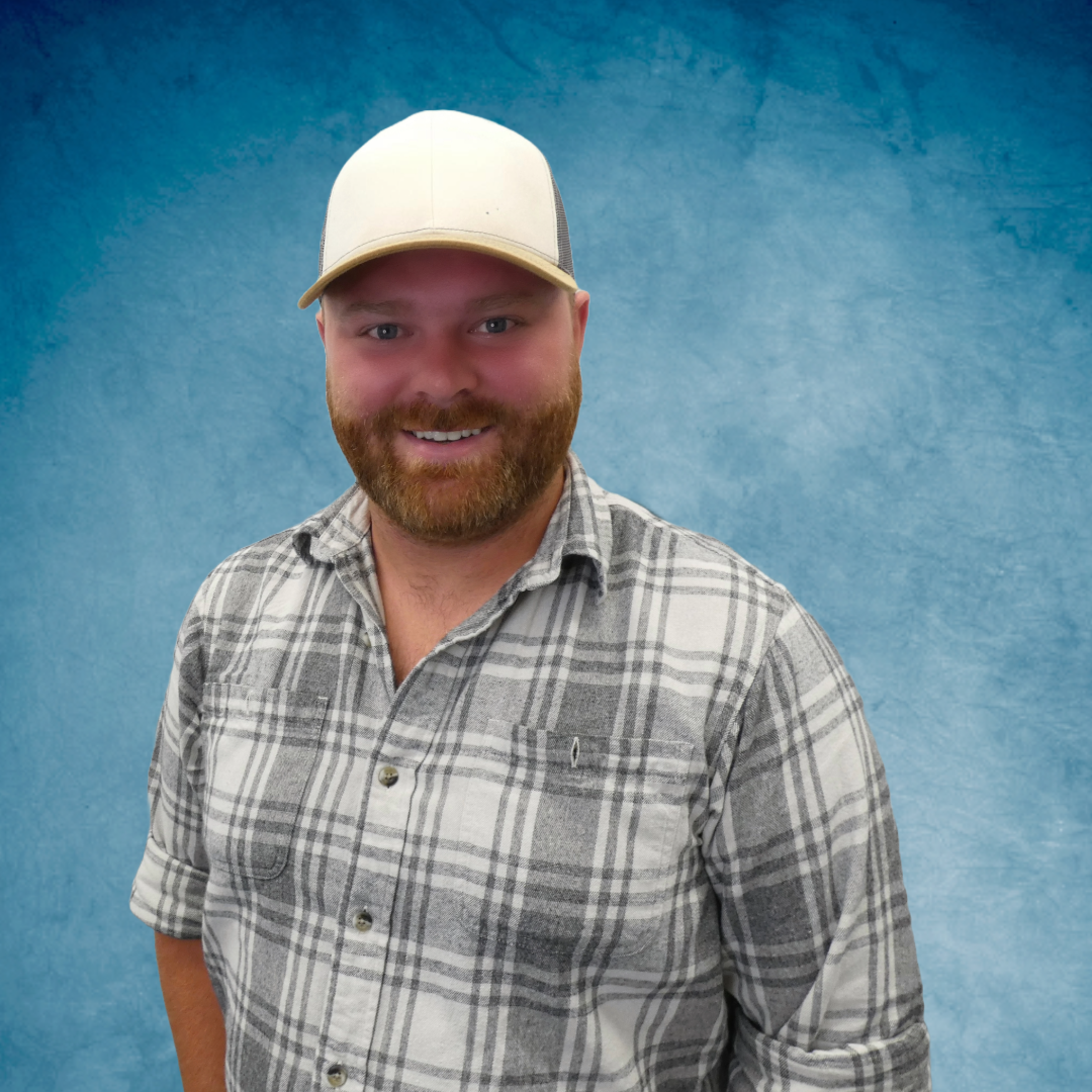 A man in a hat smiling for the camera.