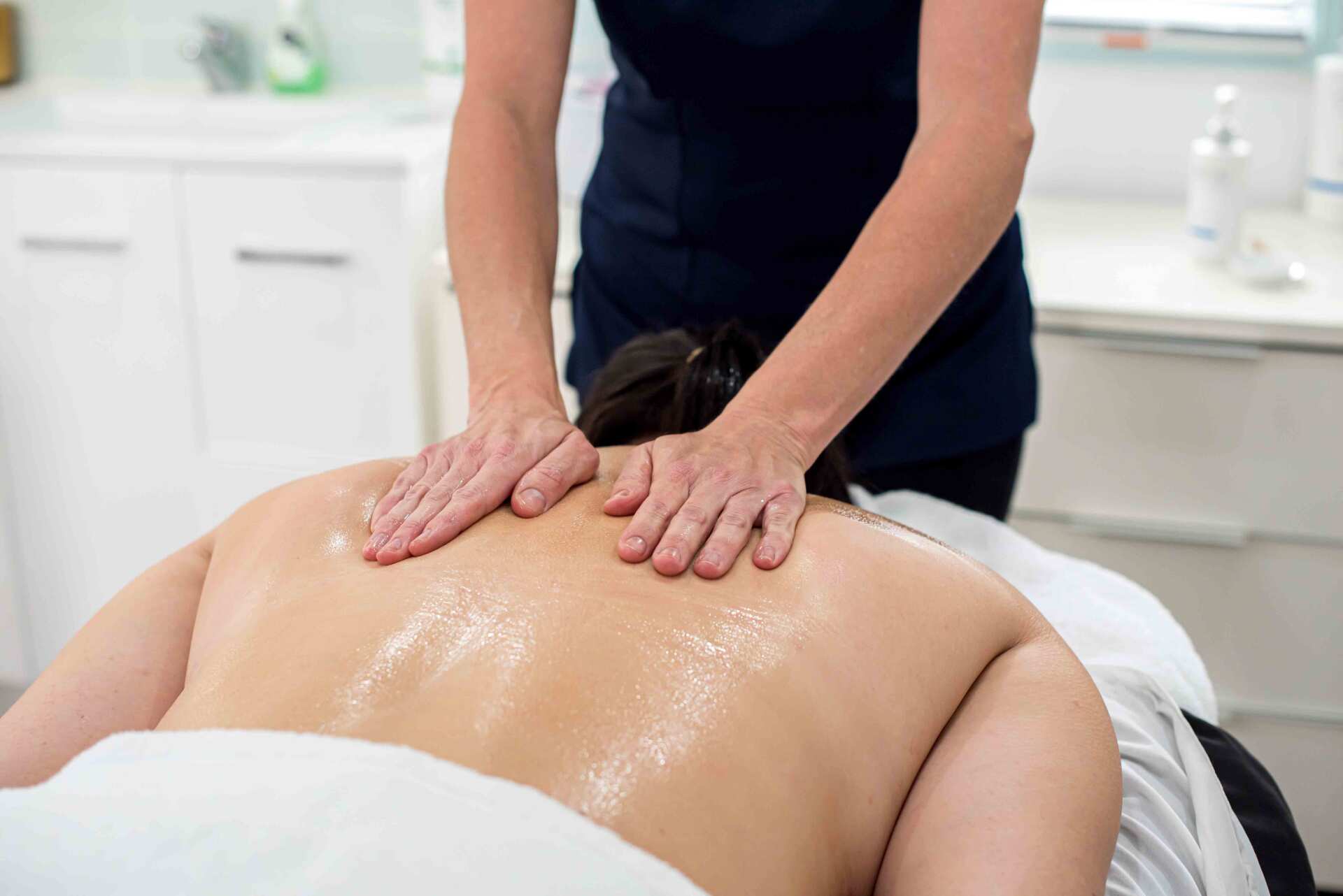 A Woman Having a Back Massage — Beauty Salon in Bundaberg, QLD