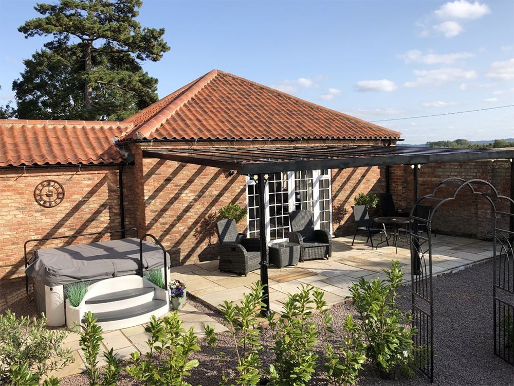 There is a hot tub in the backyard of a house.
