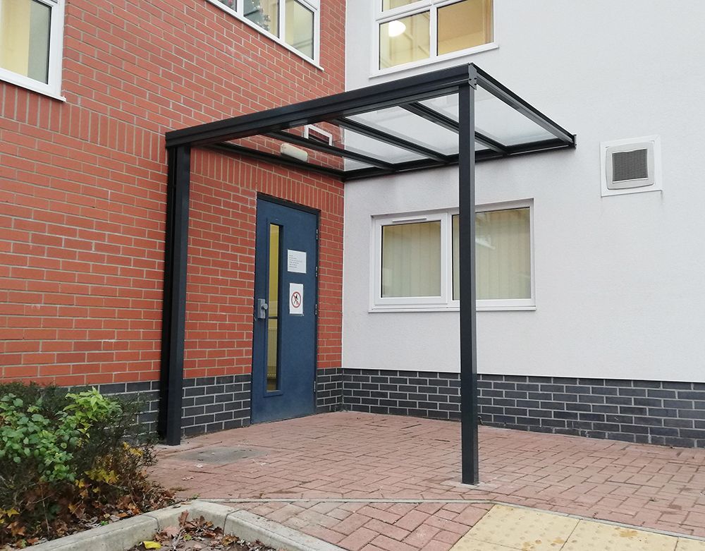 There is a canopy over the entrance to a building.