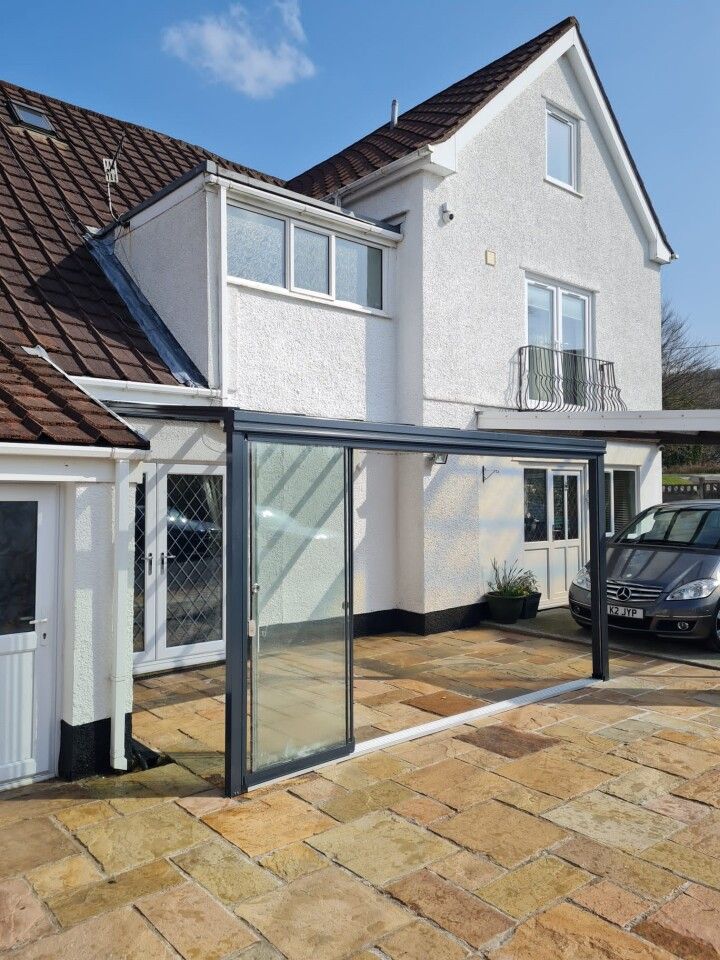 A white house with a car parked in front of it