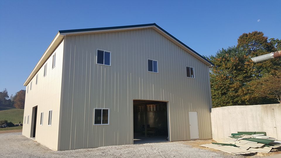 A large metal building with a lot of windows is being built.