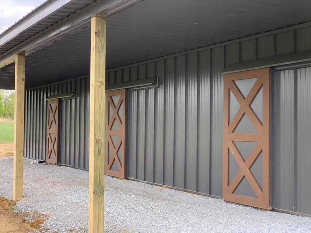 There are two barn doors on the side of a building.