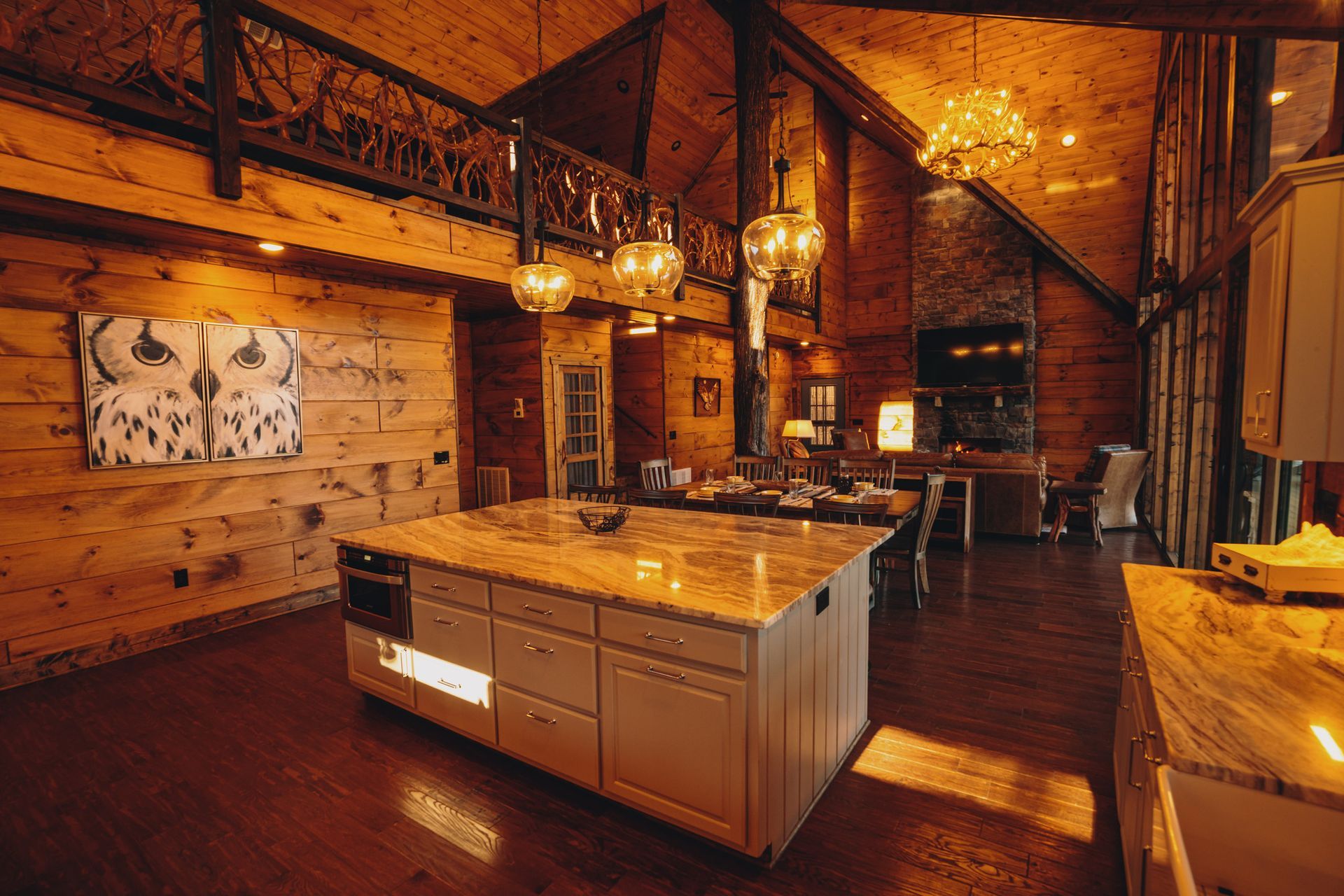 Rustic cabin kitchen with a large island and high ceilings.