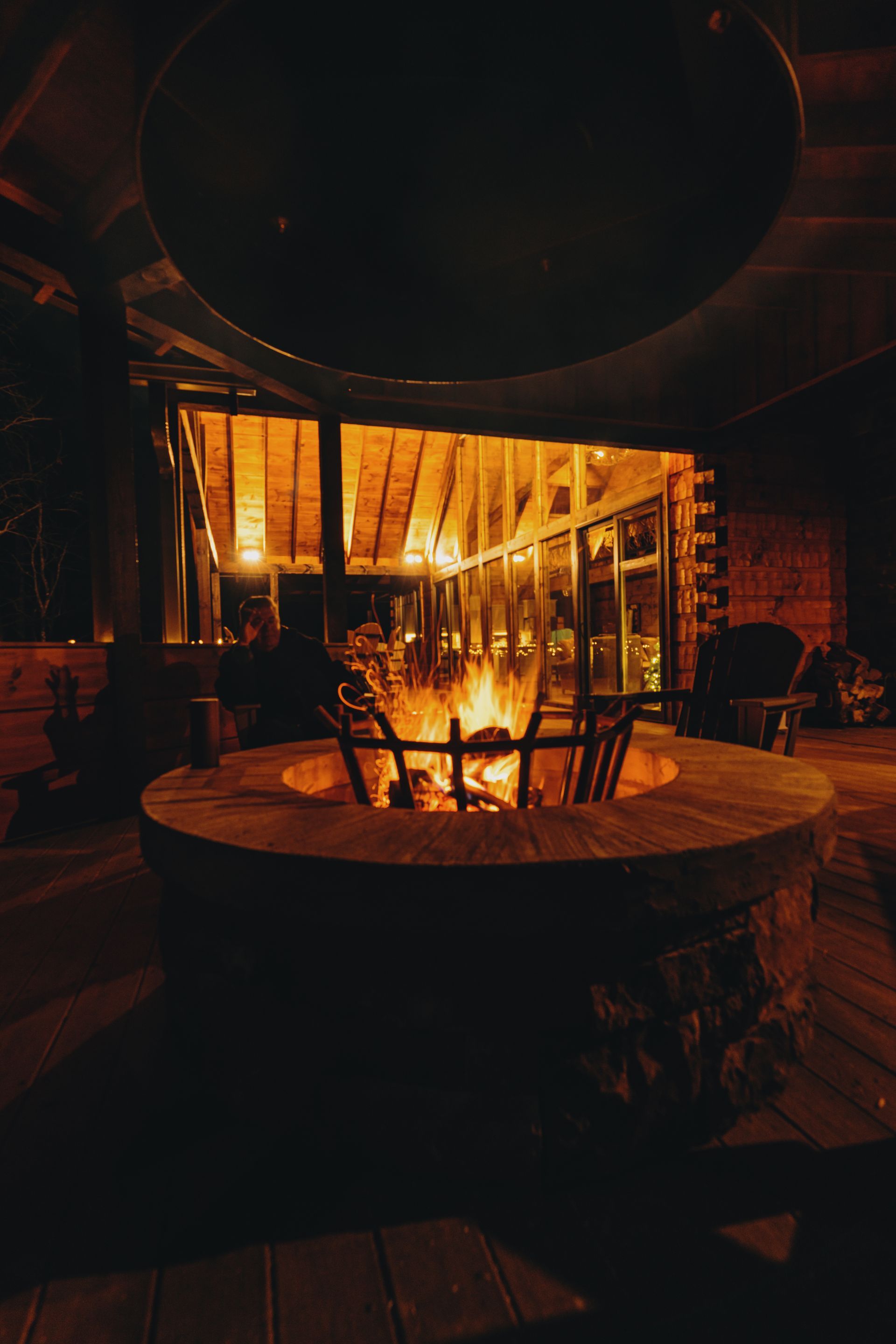 Romantic cabin bedroom with flowers, wine, chocolates, and robes on the bed.