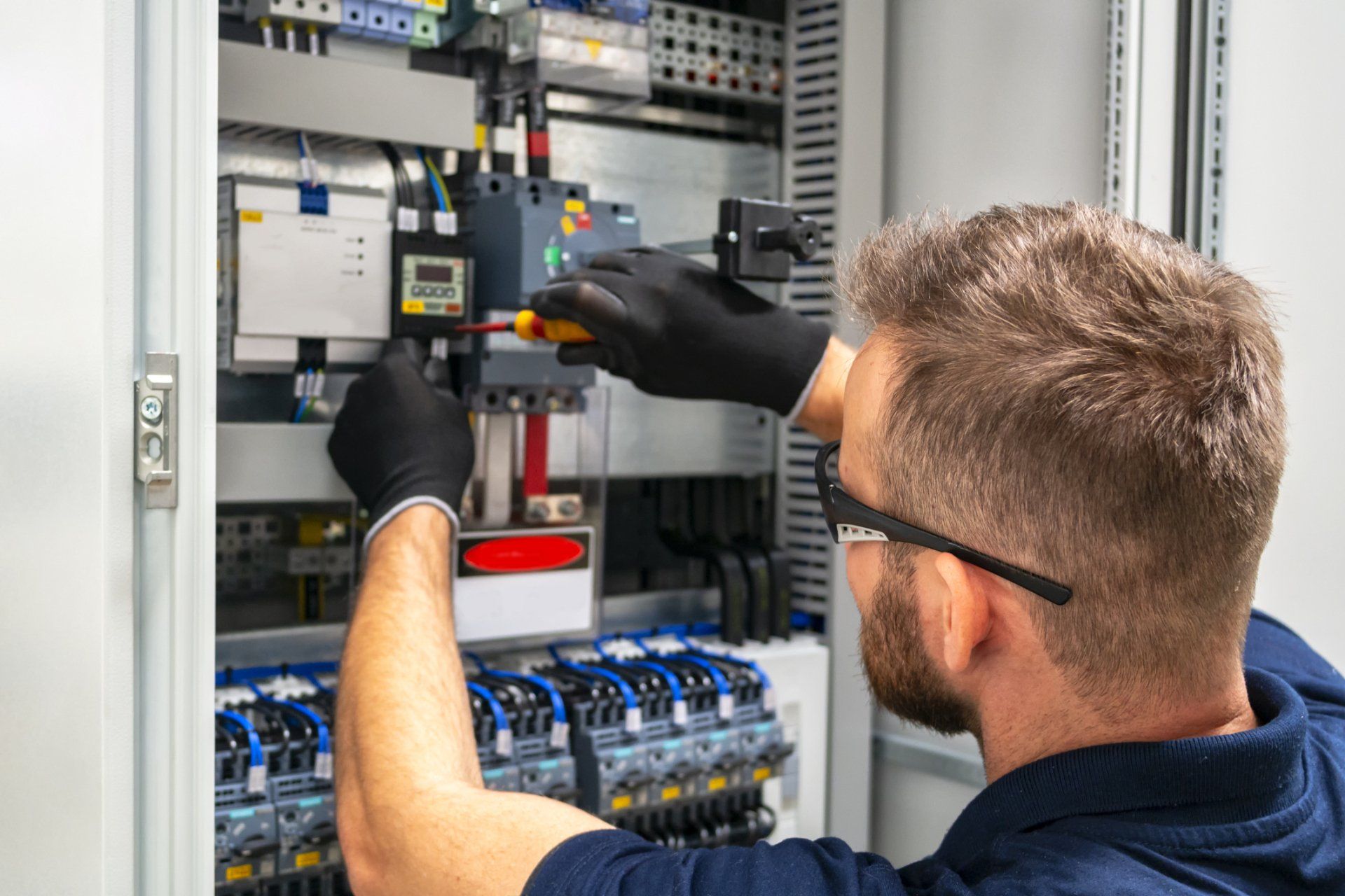Electrician Working At Electric Panel — Hervey Bay, QLD — Arctic Cold Refrigeration (Sales & Services Pty Ltd)