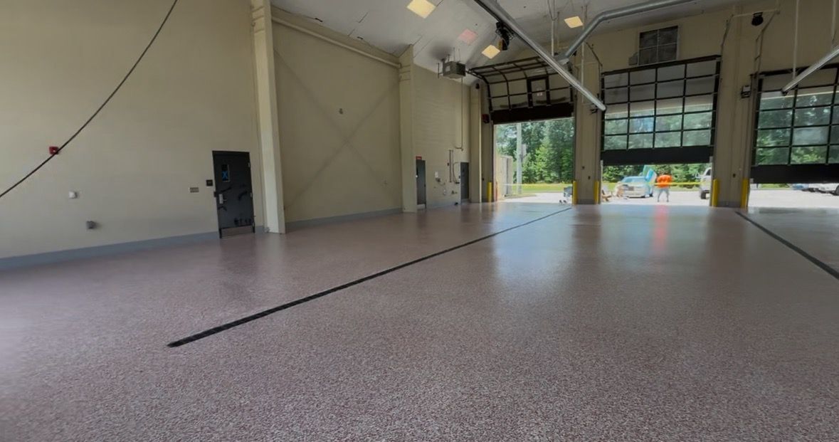 A man is laying tiles on the floor with a trowel.
