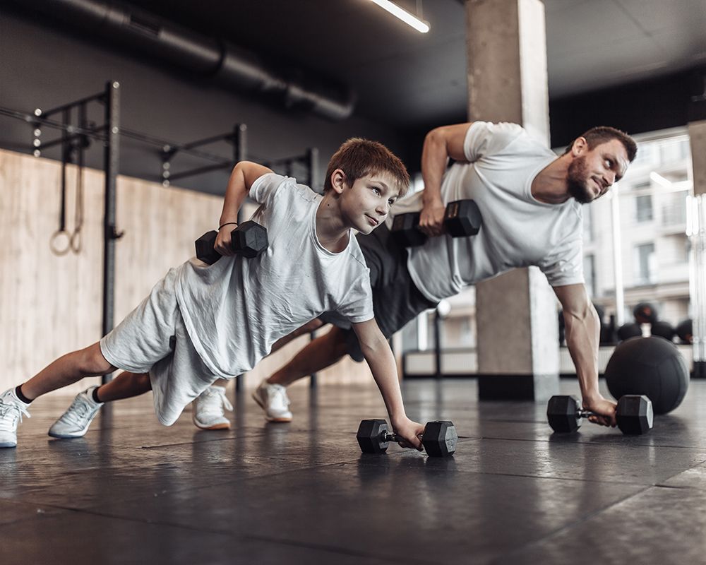 Father And Son Training Using Dumbbells