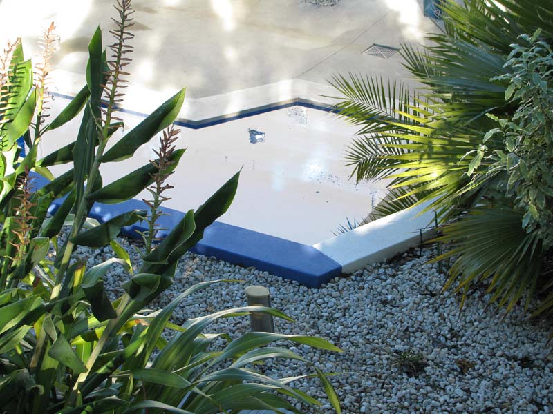 rock and greenery area by pool
