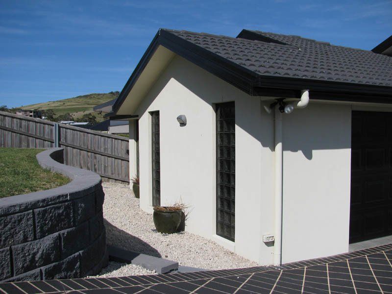 home with white walls and black roof
