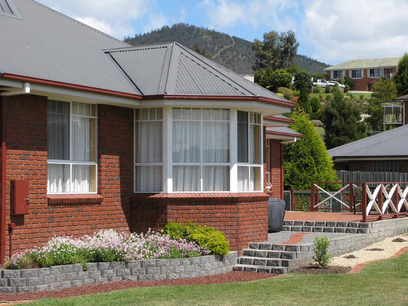 red brick home exterior with windows