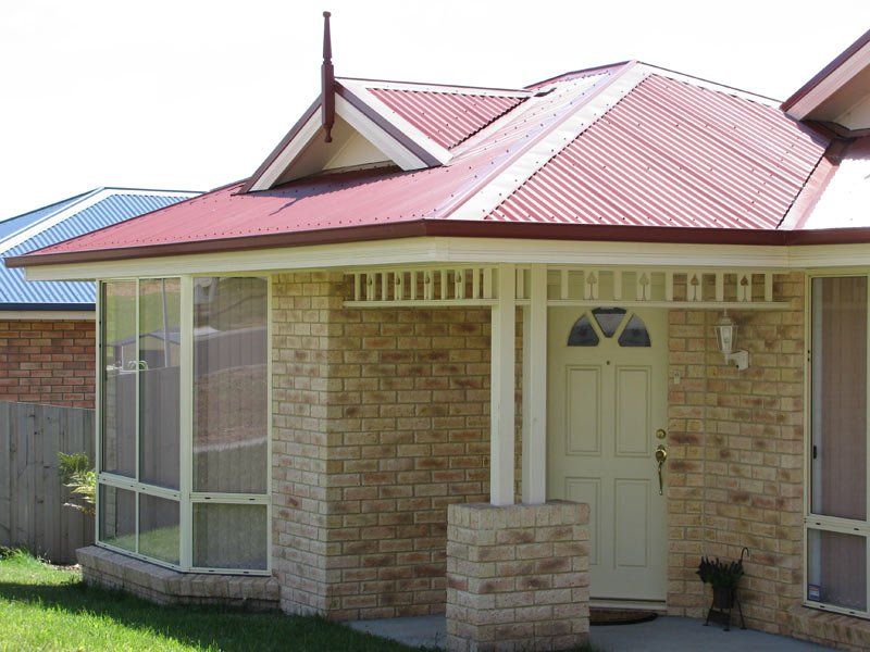light brick home with white front door