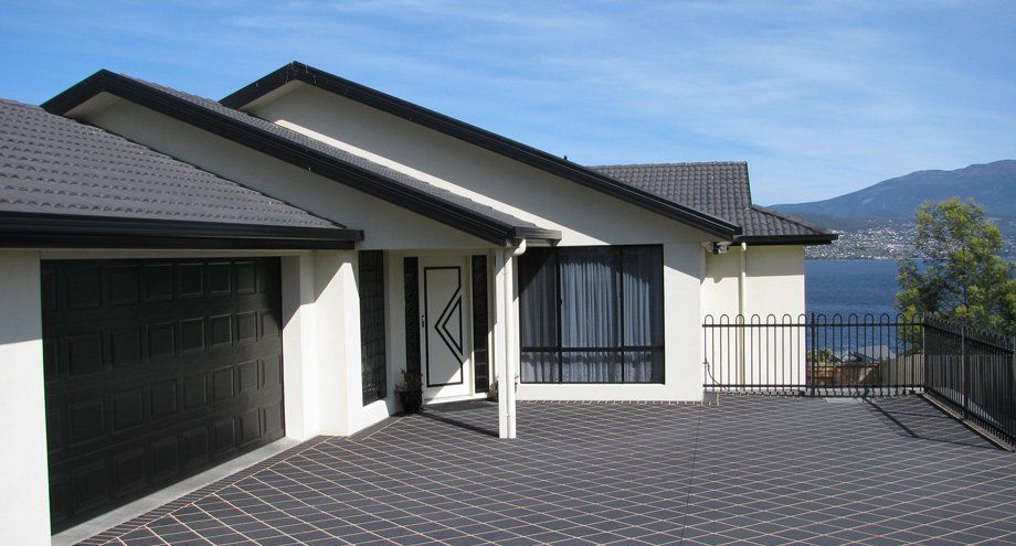 gray deck with garage in front of home