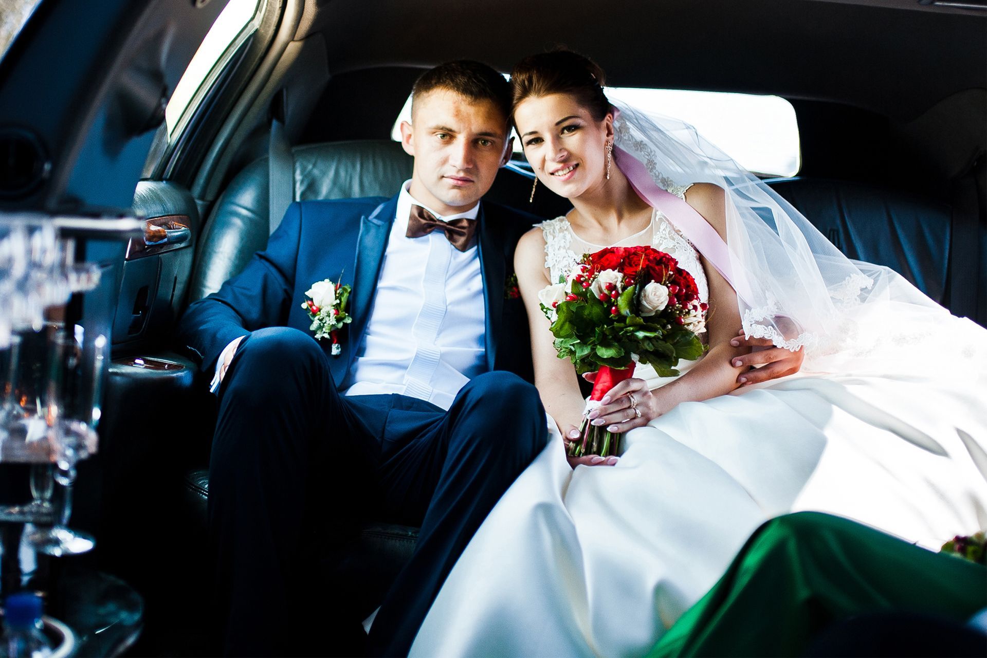 Newlyweds in a limousine.