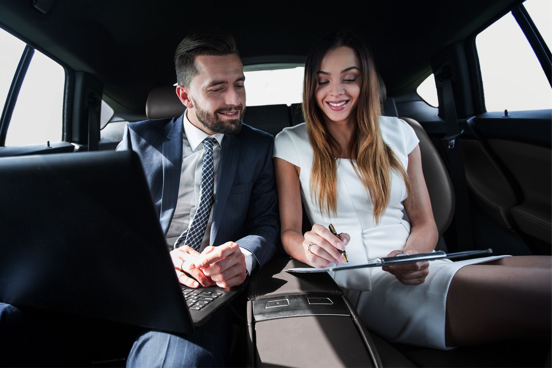 Bride and groom inside a limousine.