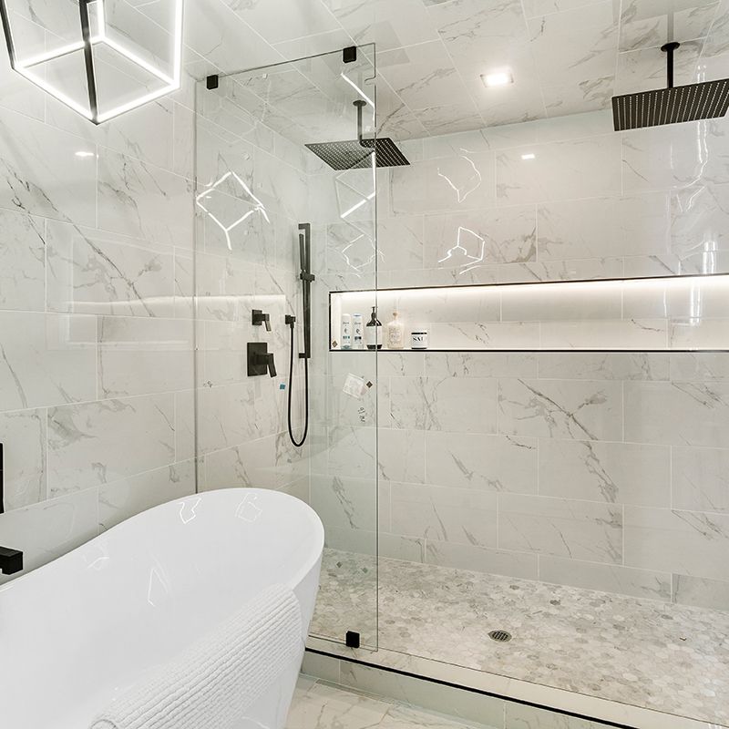 A bathroom with a bathtub and a walk in shower.