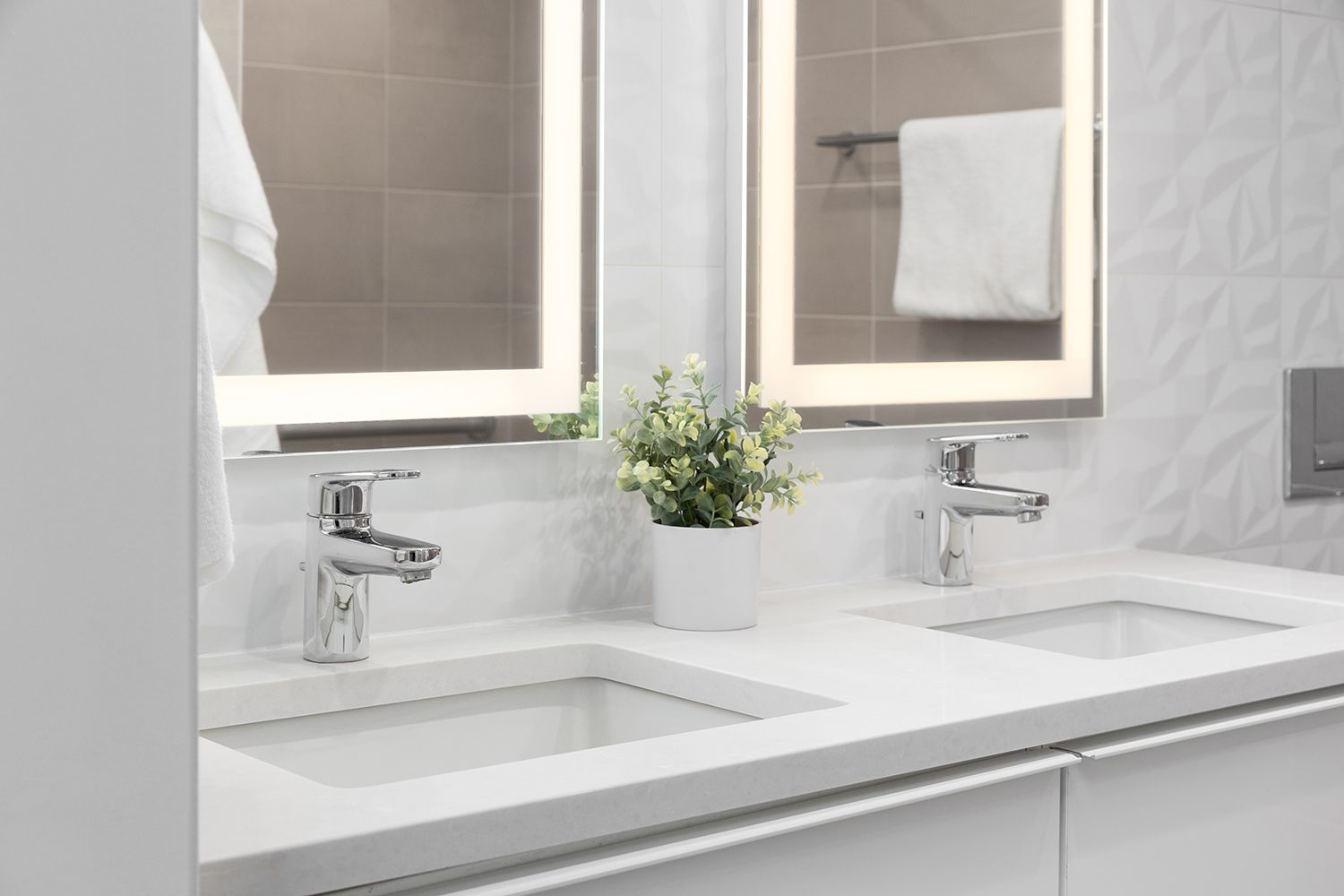 A bathroom with two sinks and two mirrors.