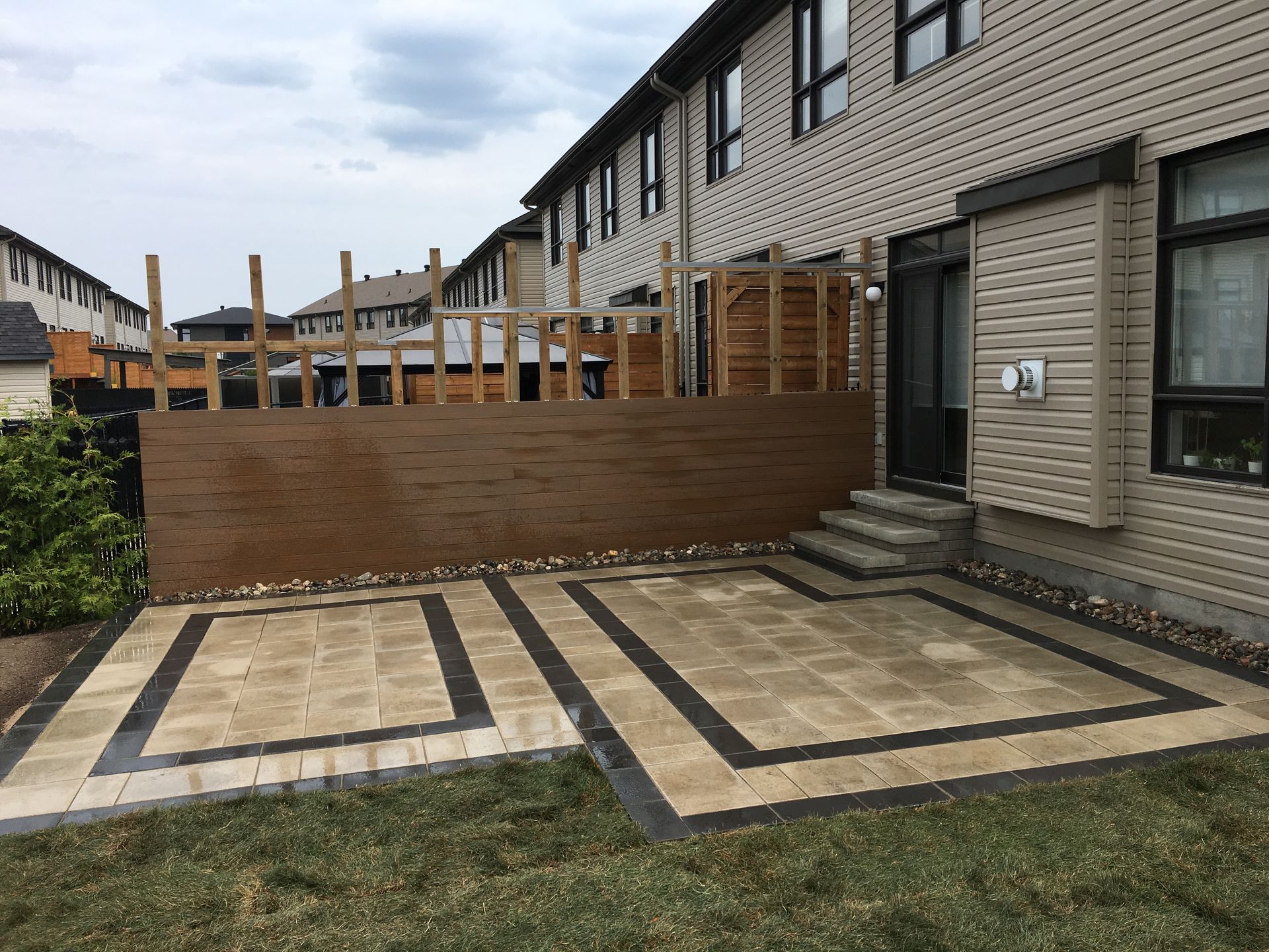 A patio is being built in front of a house.