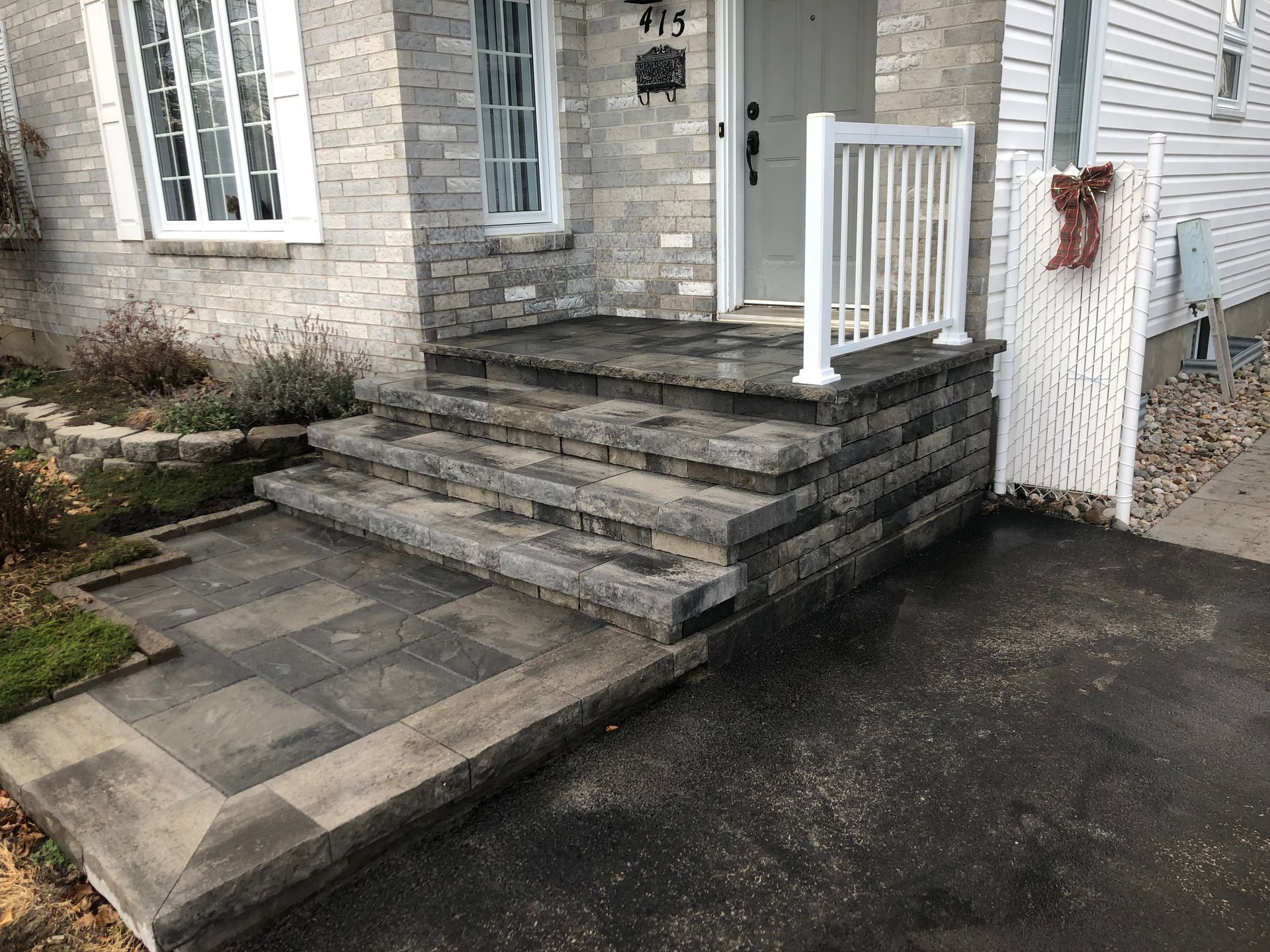 There are stairs leading up to the front door of a house.