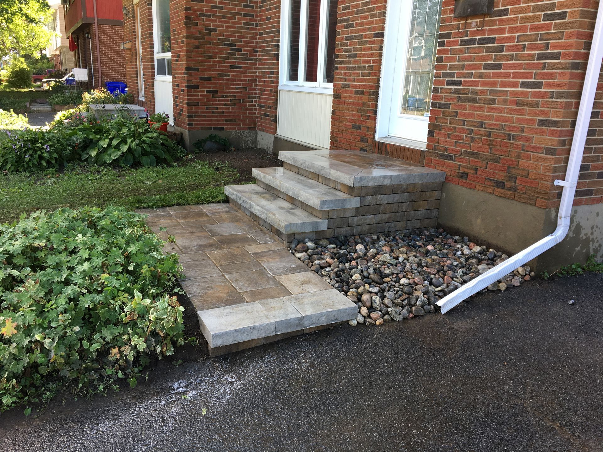 A brick house with steps leading up to the front door.
