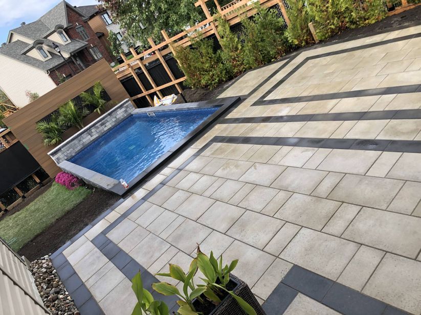 A patio with a swimming pool in the middle of it.