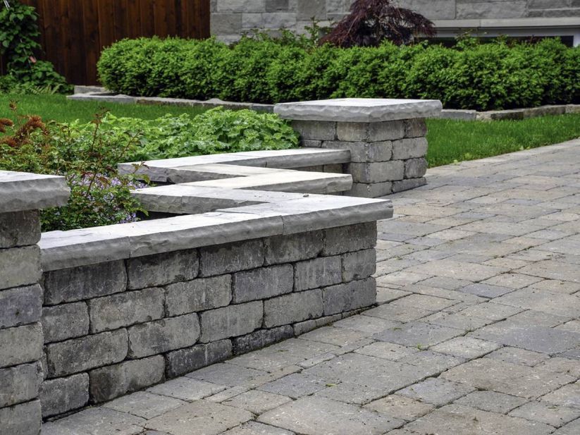 A brick wall with a bench on top of it