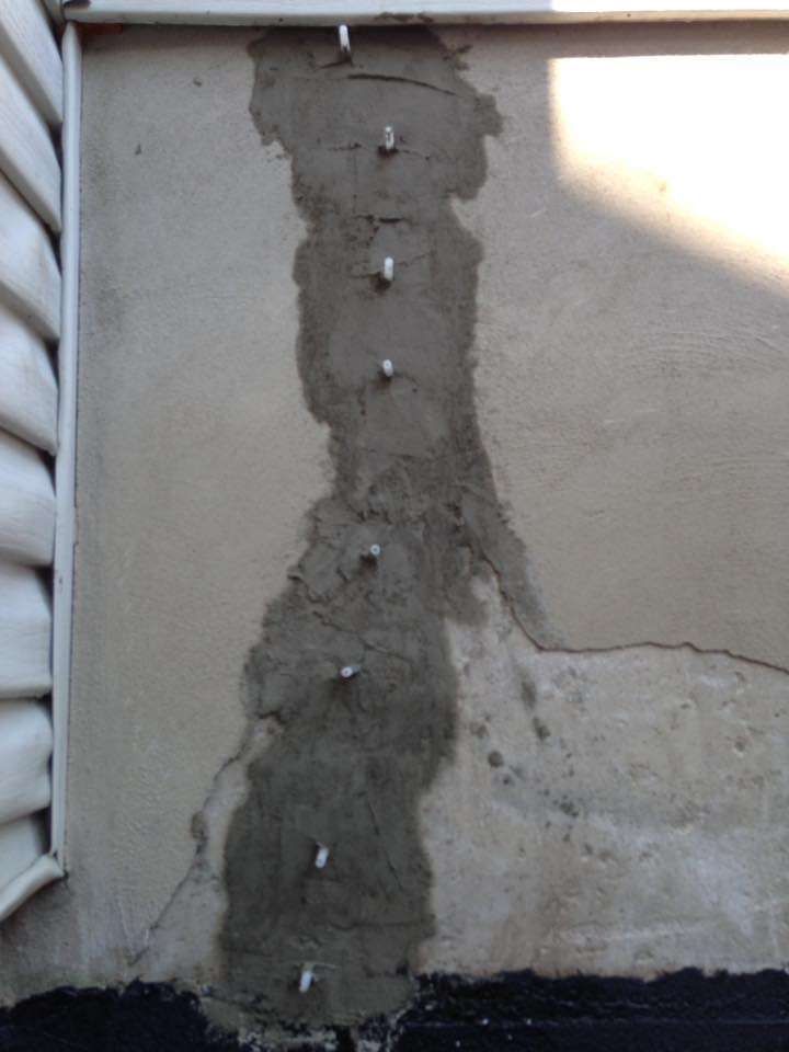 A close up of a wall with screws in it.