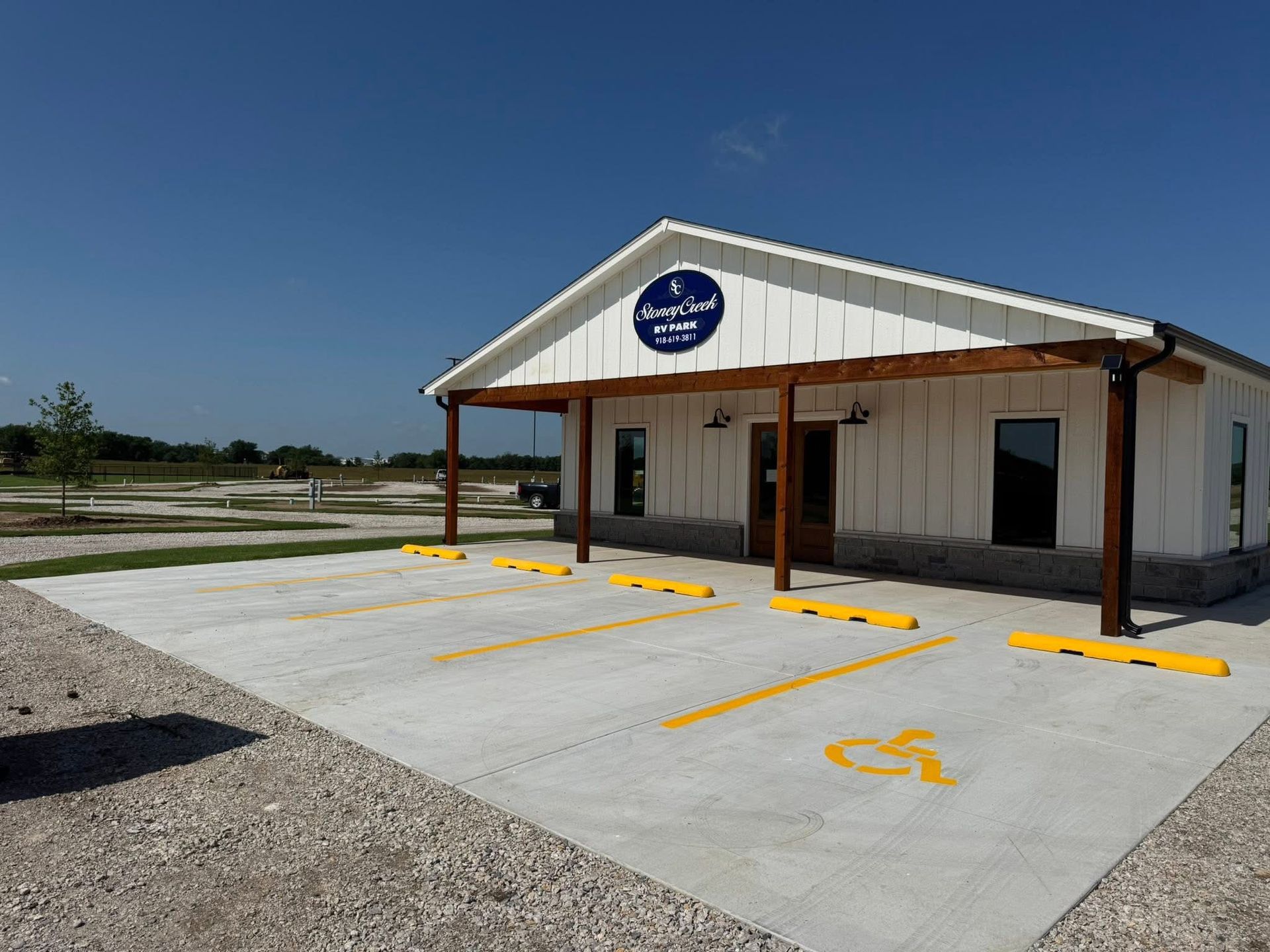 A white building with a handicapped parking spot in front of it