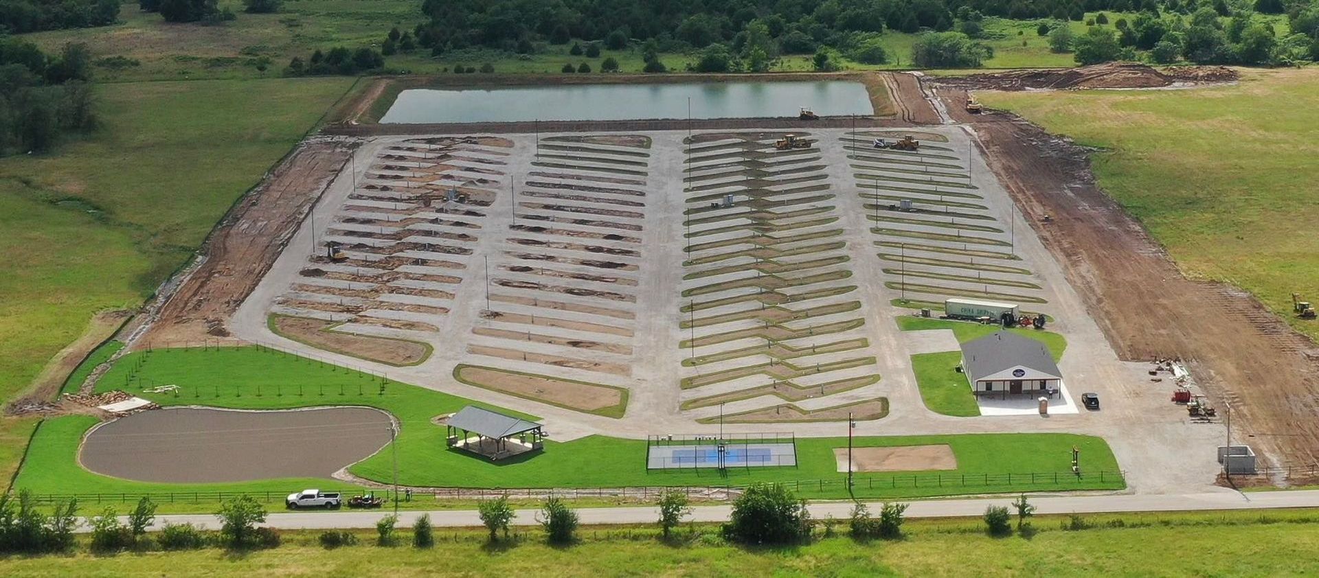An aerial view of a park with a lot of cars parked in it.