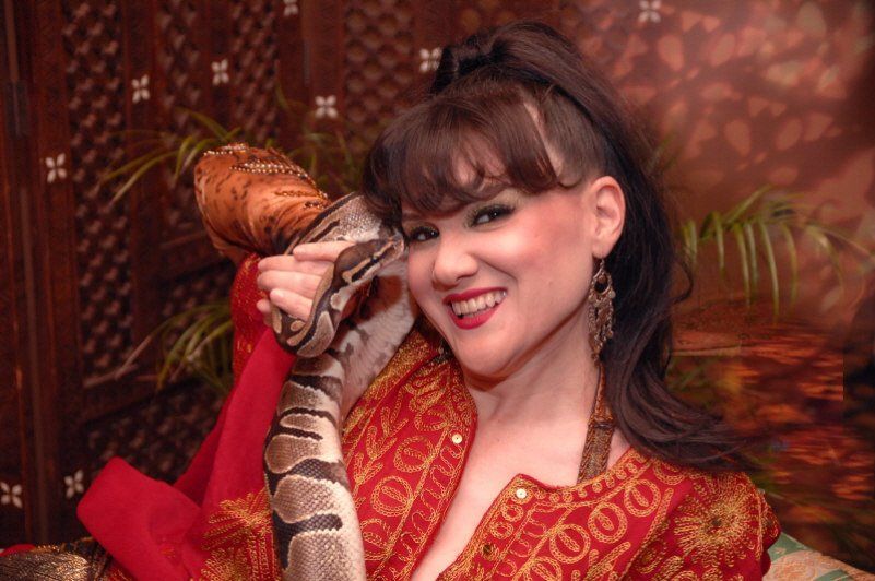 Exotic animals image showing female snake charmer with snake