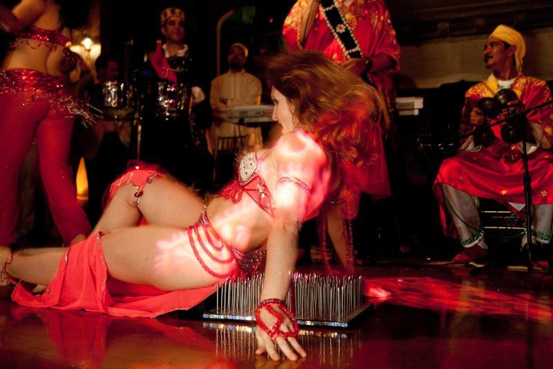 Specialty acts image showing performer on a bed of nails during stage performance