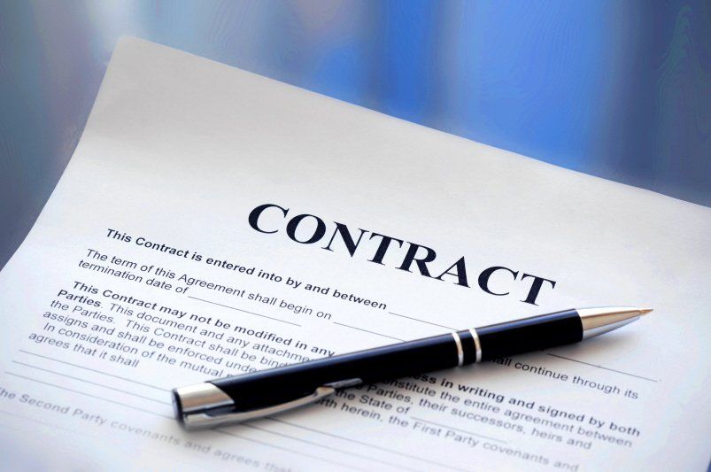 a pen sits on top of a contract form