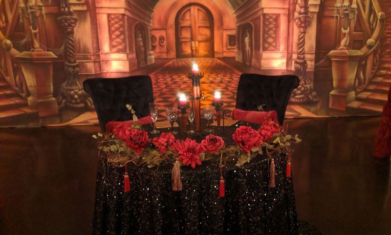 Gothic Themed Wedding  table and chair setting with flowers and candles