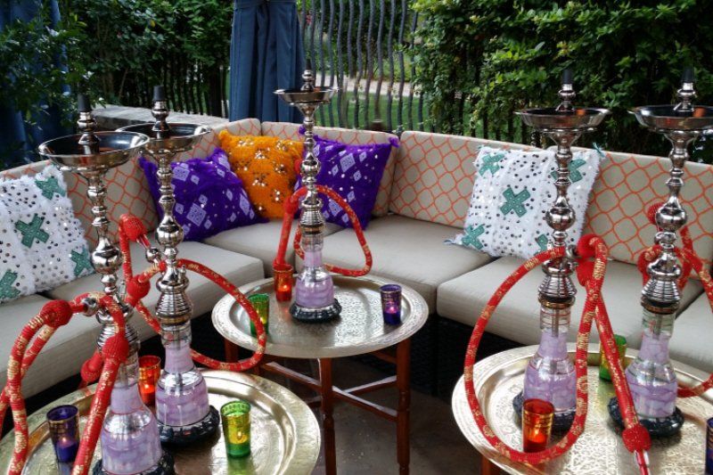 Hookah lounge with many hookah pipes on brass trays
