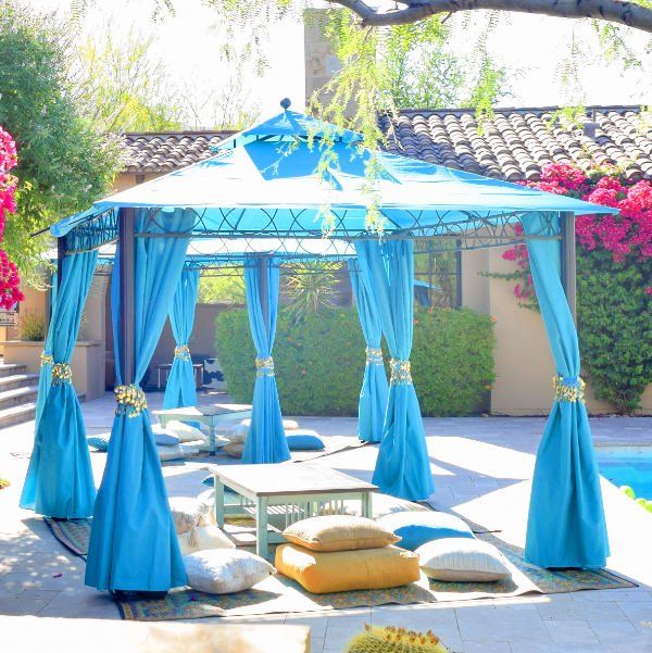 Turquoise Blue Tent with floor cushions by the pool