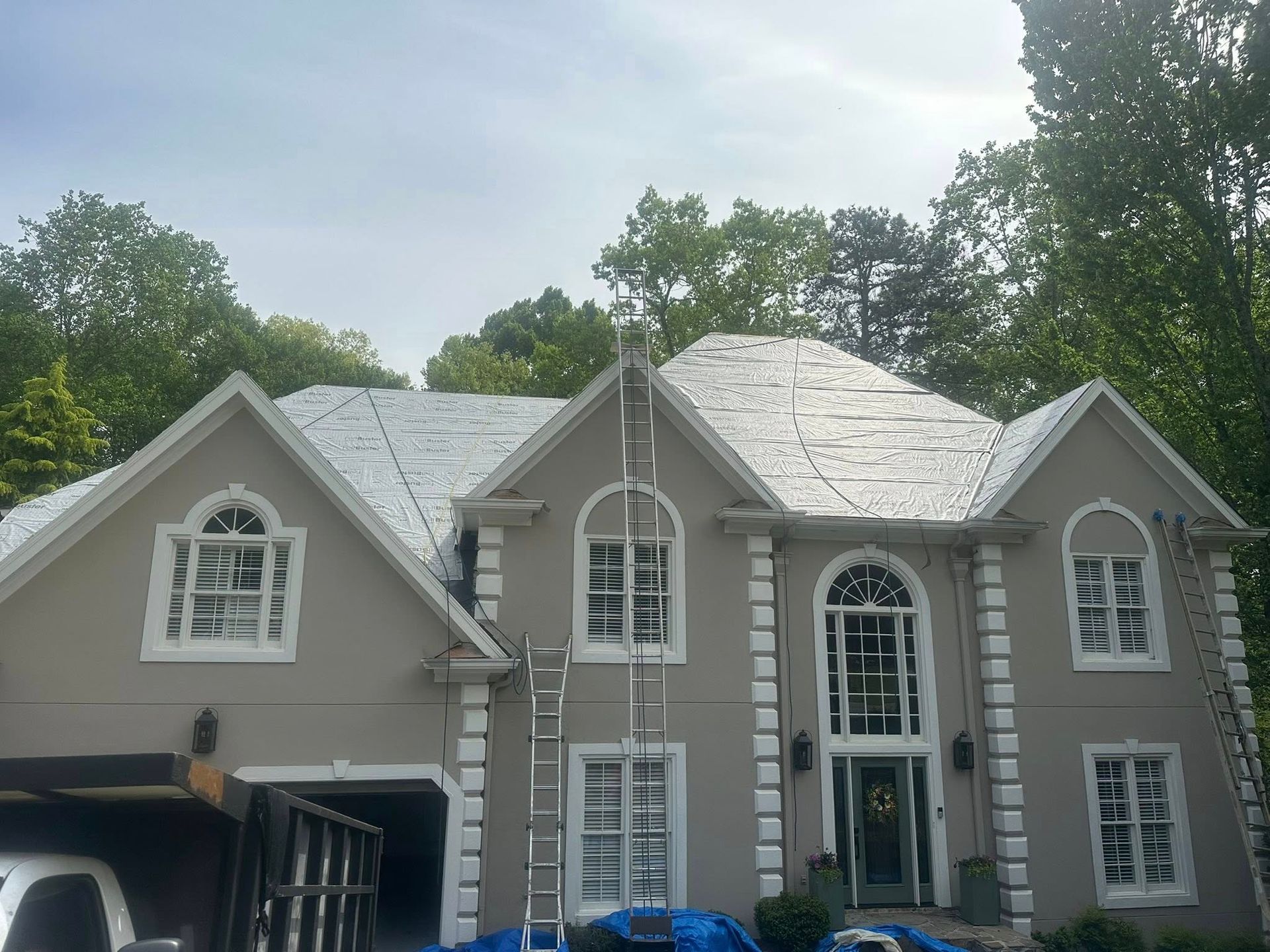 A large house with a ladder in front of it.