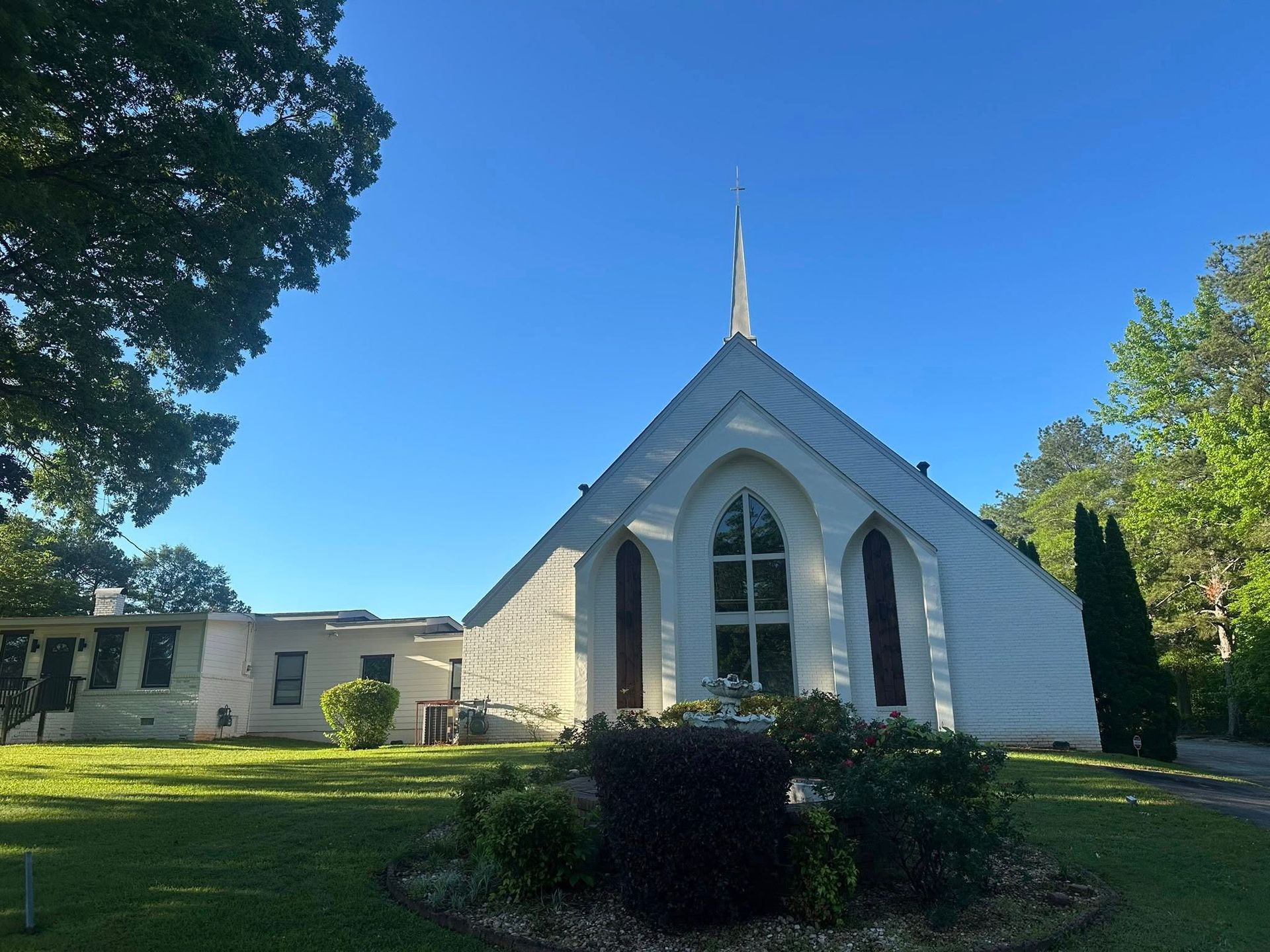 A small white church with a cross on top of it