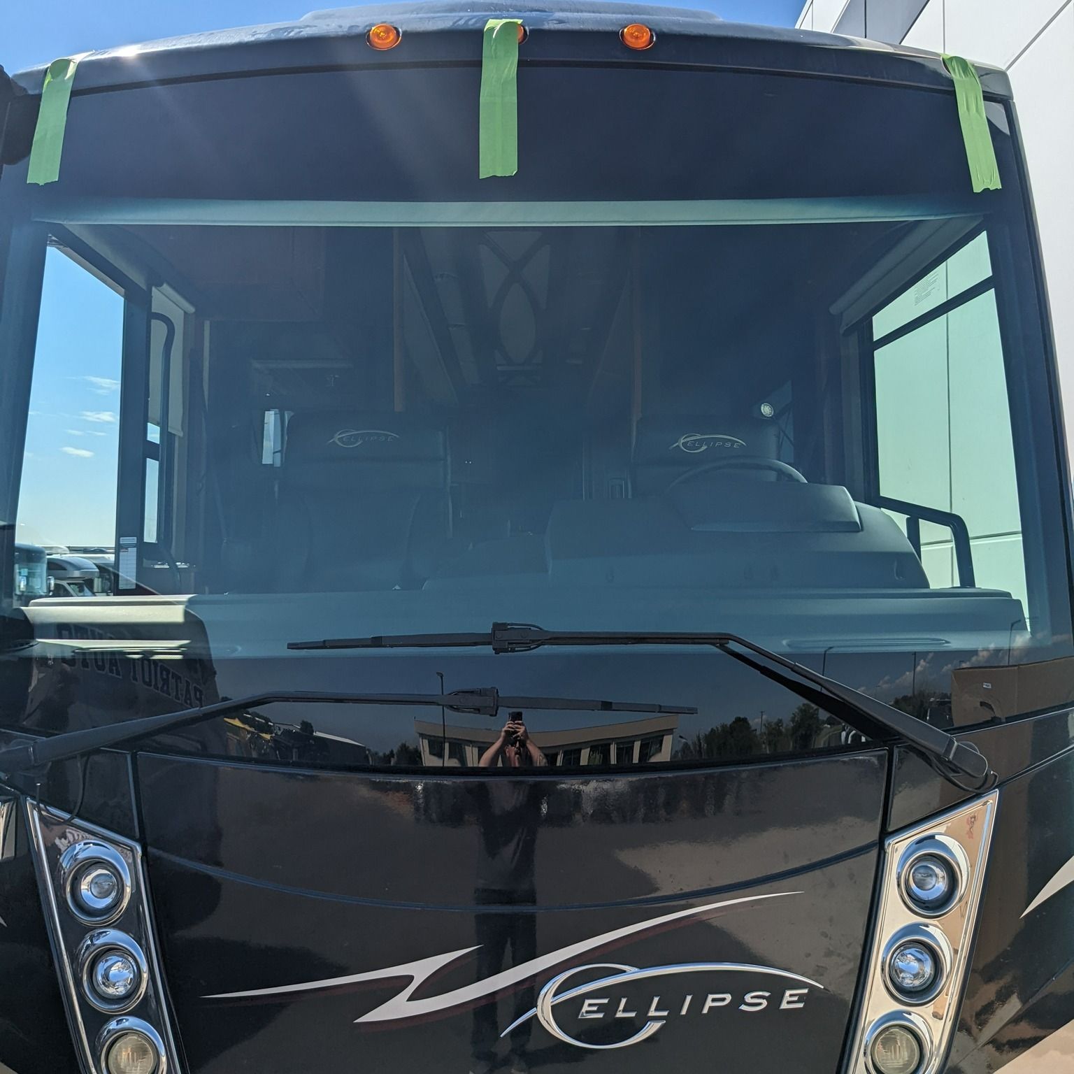 A black eclipse bus is parked in front of a building.
