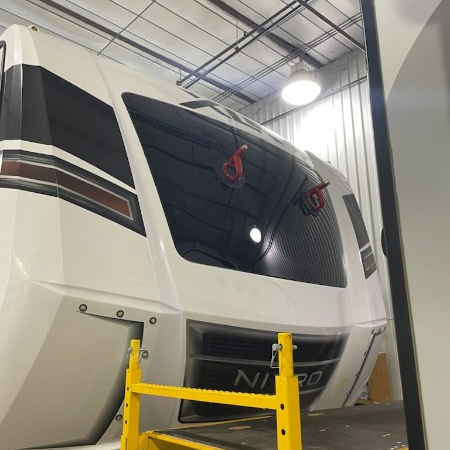 A large white vehicle with the word nitro on the front