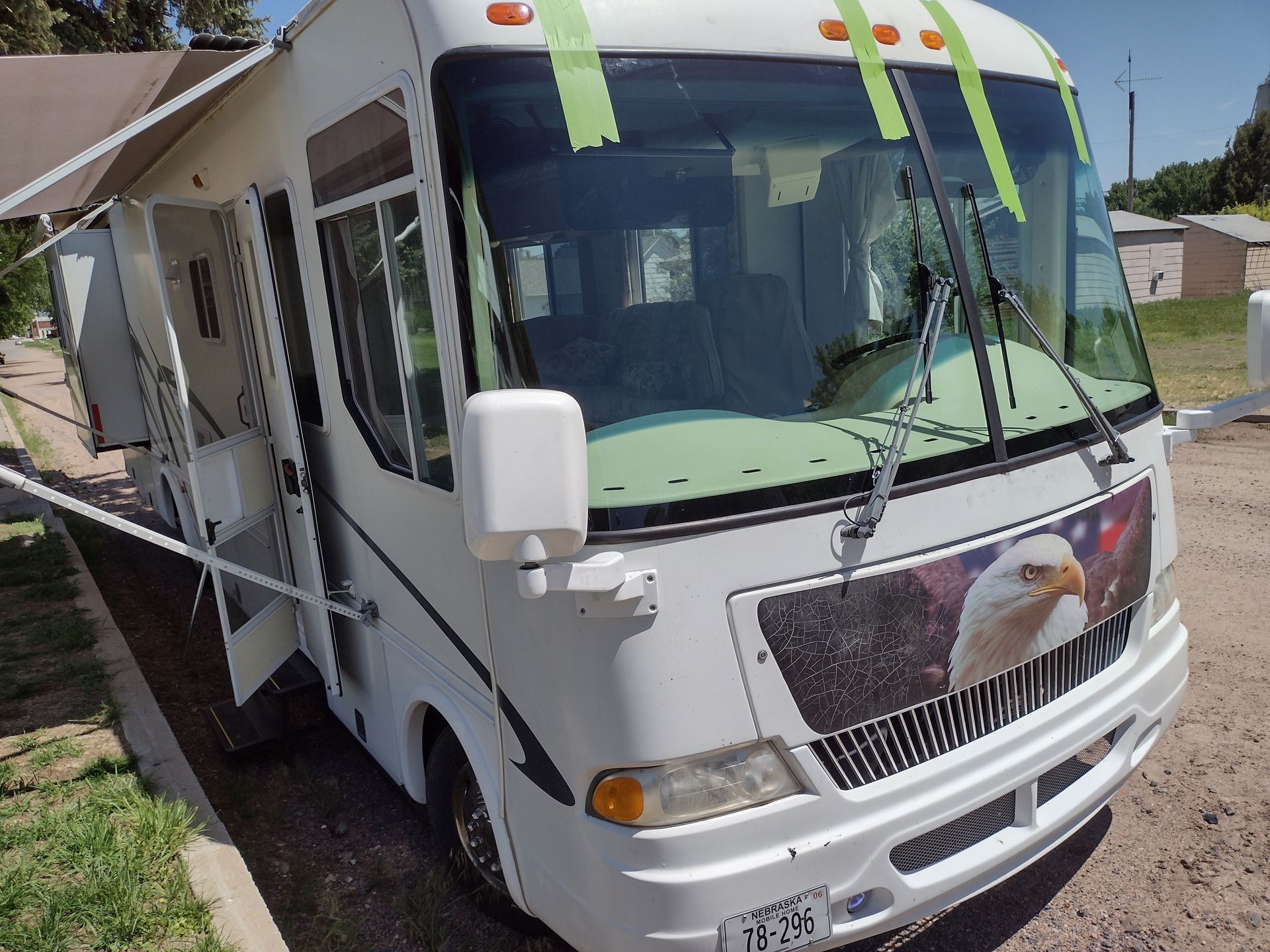 A white bus with a picture of an eagle on the front