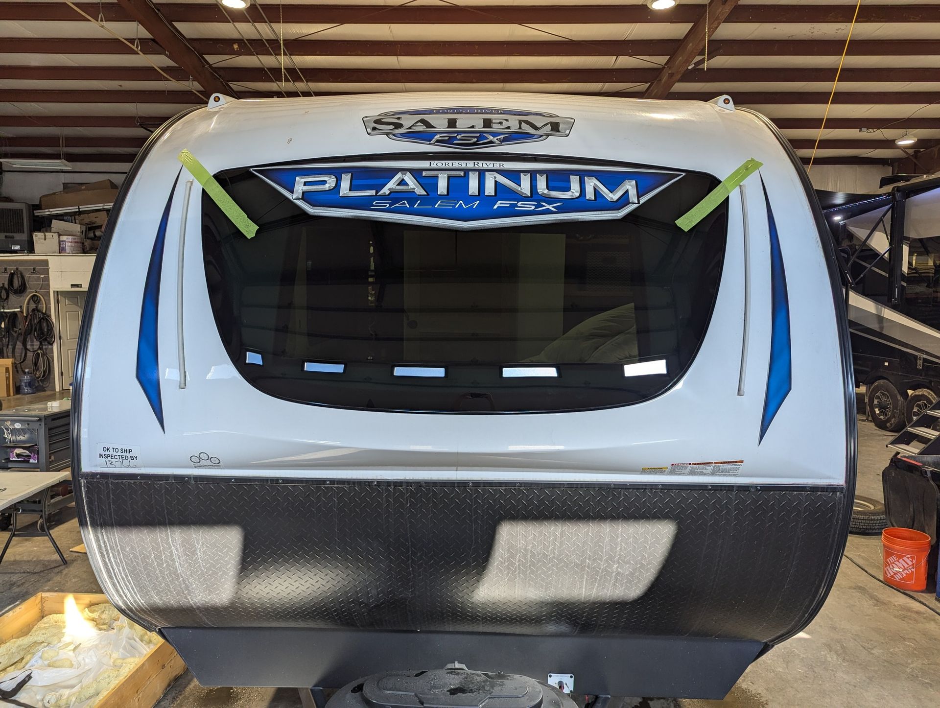 A platinum trailer is being repaired in a garage
