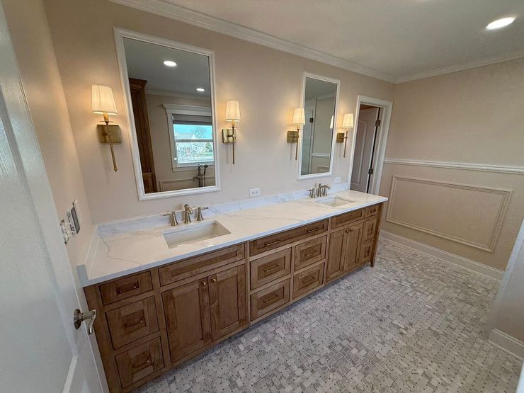 Hands framing a bathroom design, overlaying a realistic photo onto a schematic sketch of the room layout.