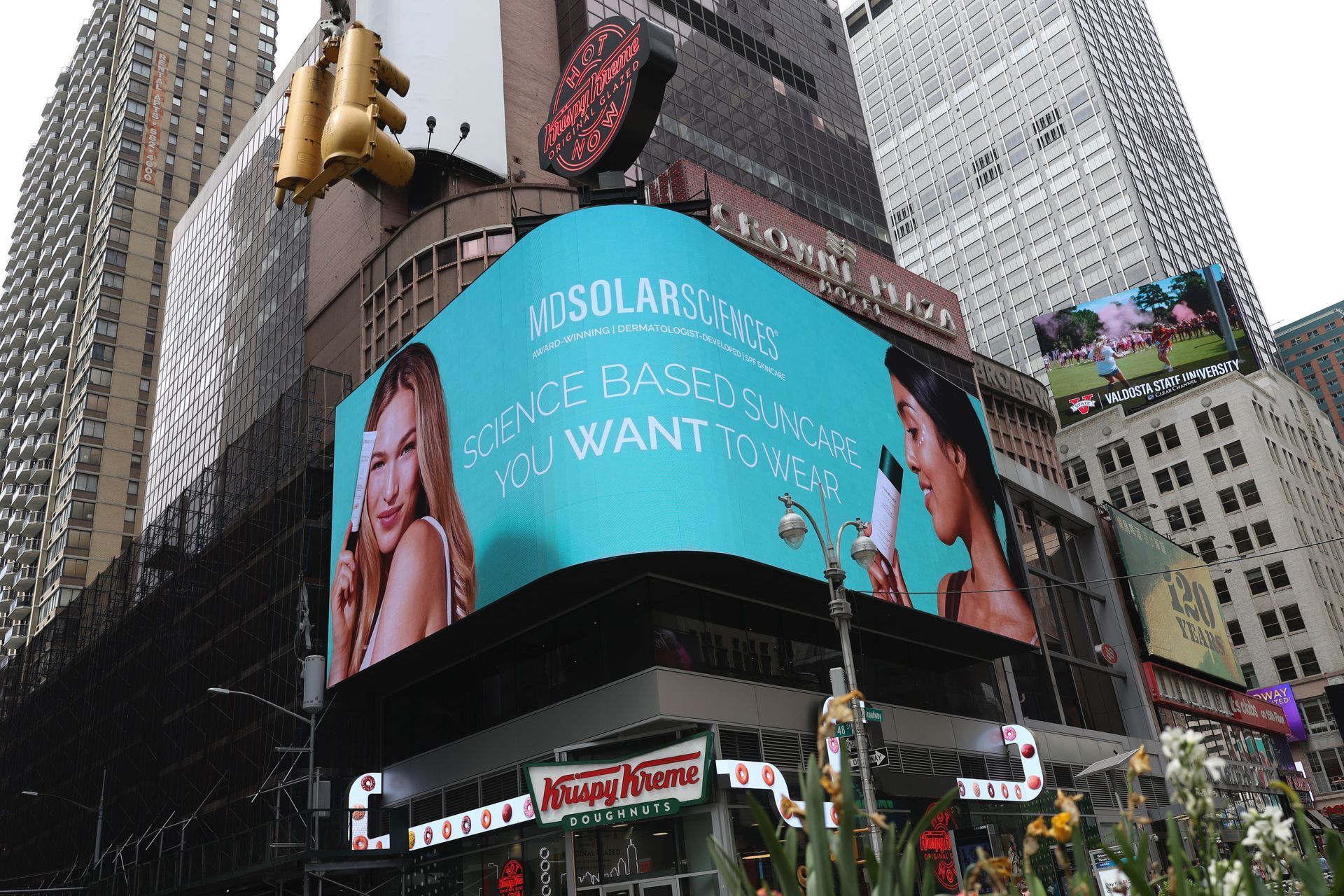 A large billboard on the side of a building that says ' MDSolarSciences ' on it