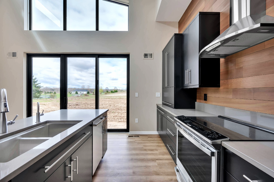 Open kitchen next to floor to ceiling windows