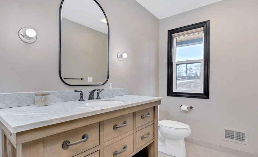 Contemporary bathroom in new home construction with open light bulb design