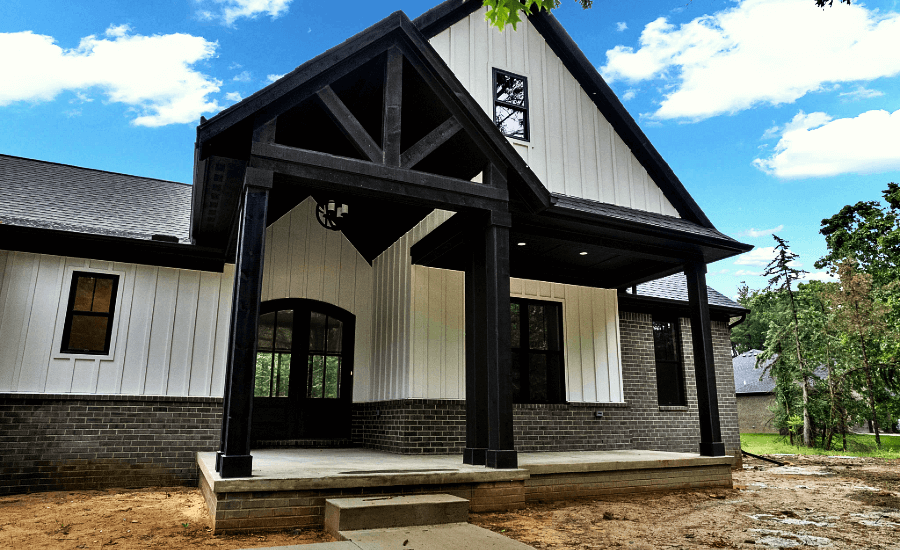 Striking black wood beam structured portico on new house